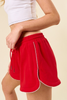 red drawstring shorts with white scalloped binding trim